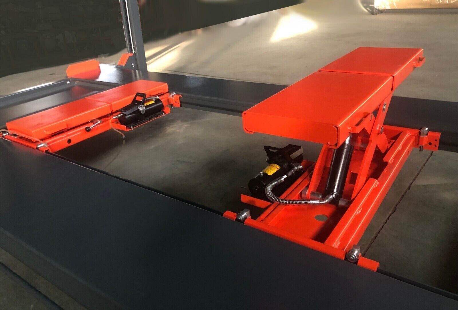 Two KT-RJ50 rolling jacks shown on a four-post lift